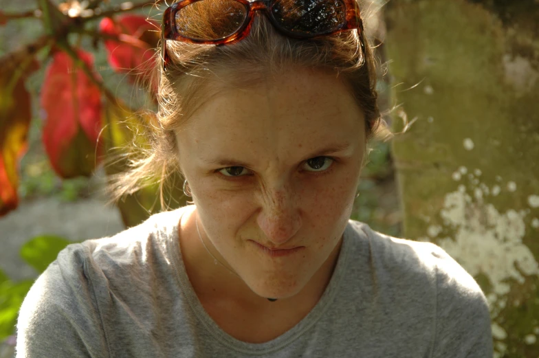 a close up of a person wearing sunglasses and a t - shirt