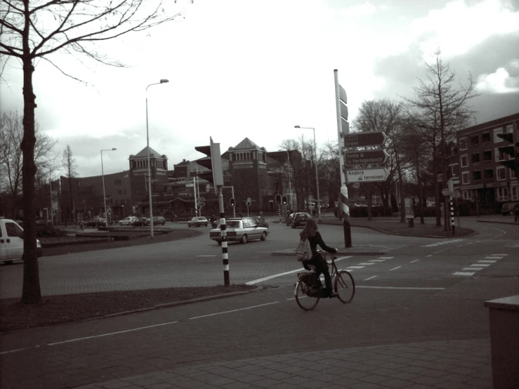 a person riding a bike down a sidewalk