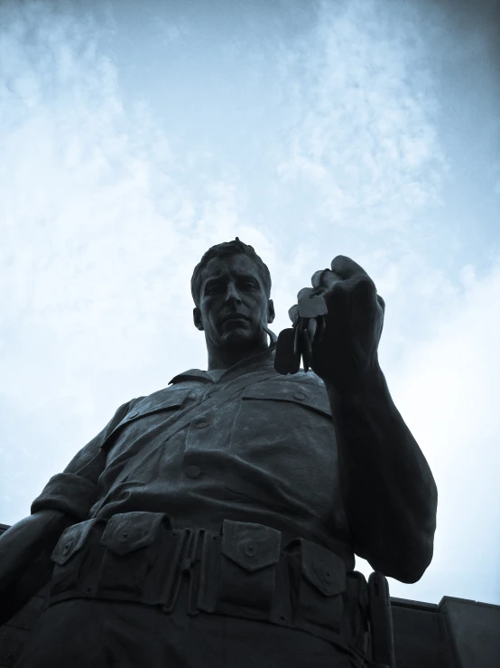 a statue of a soldier sitting on a bench