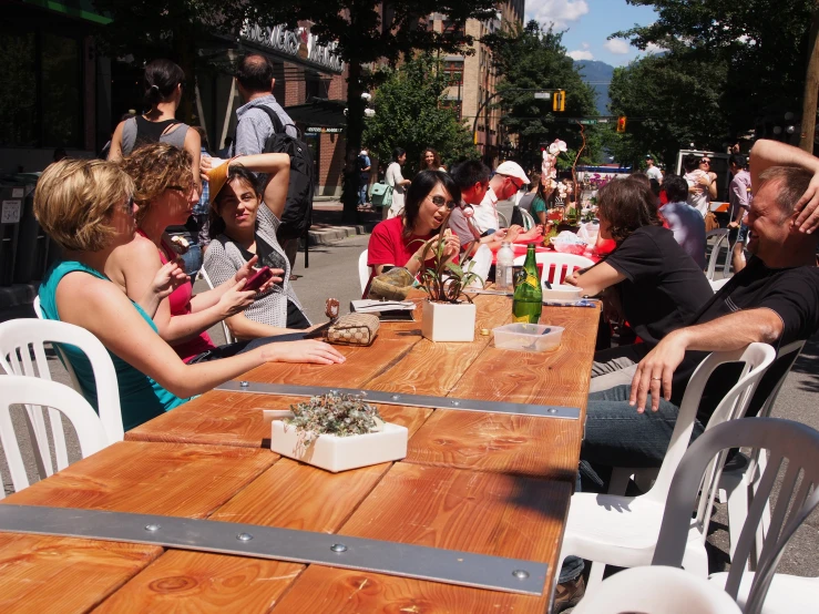 a group of people sitting at a wooden table