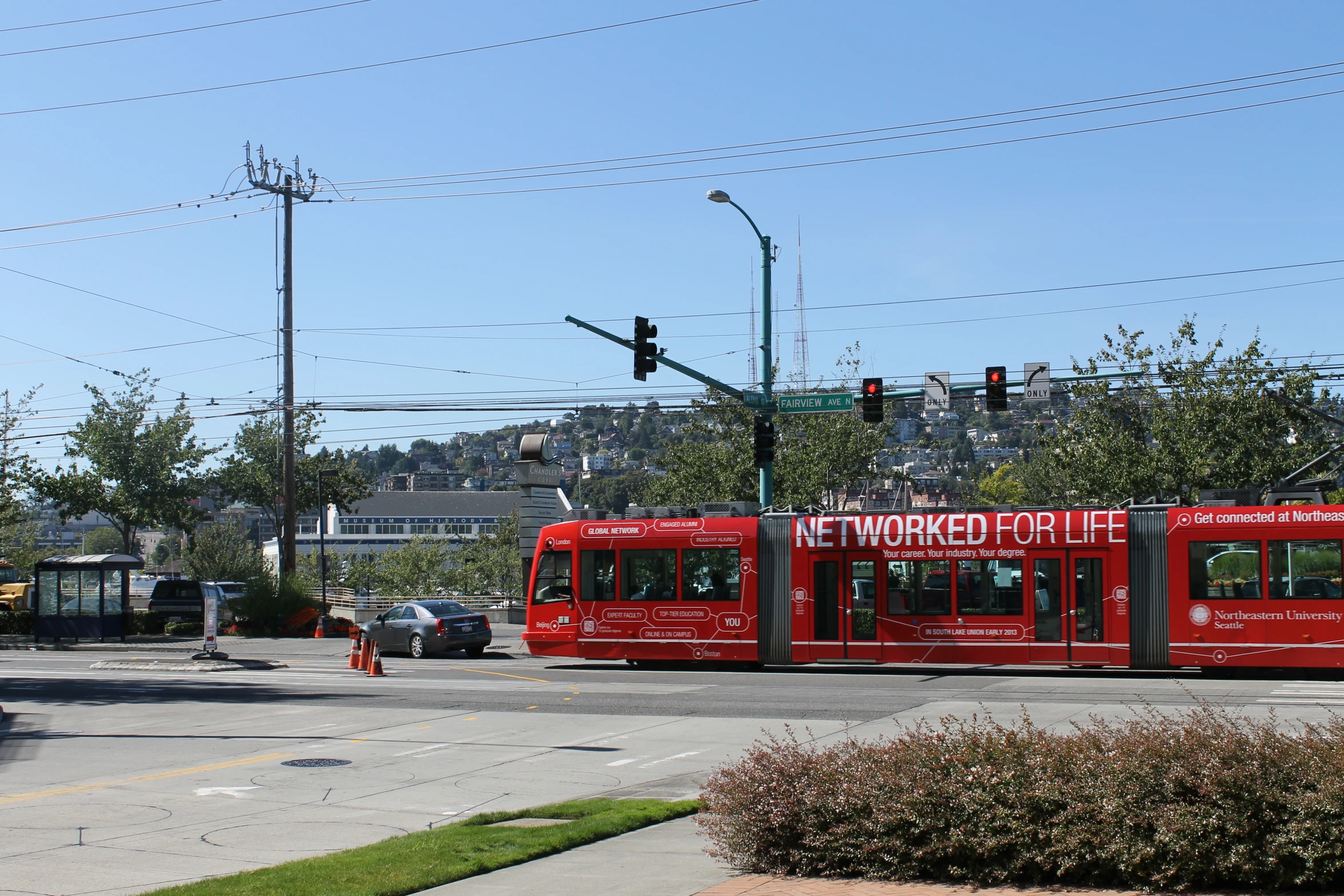 an old fashioned streetcar stopped at a street intersection