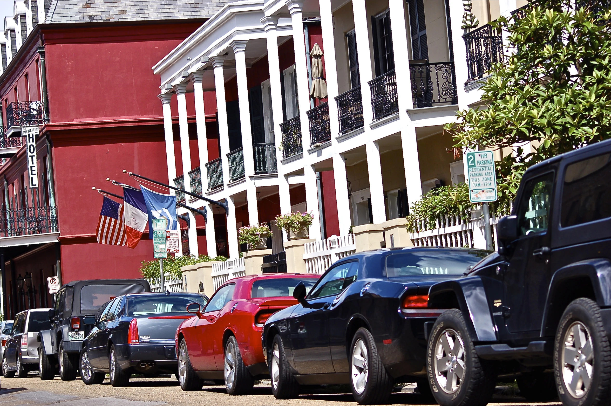 many cars parked on the side of a street