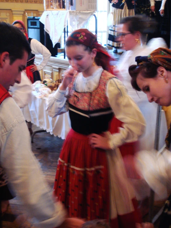 two women in costumes standing next to a man