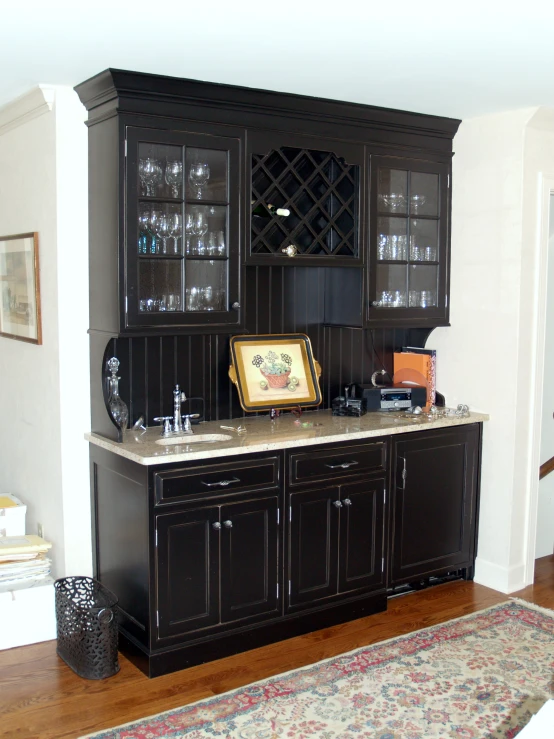 a large cabinet with glass shelves that is well decorated
