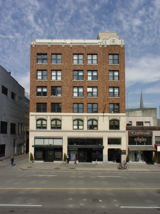 a tall brick building with two stories and some windows