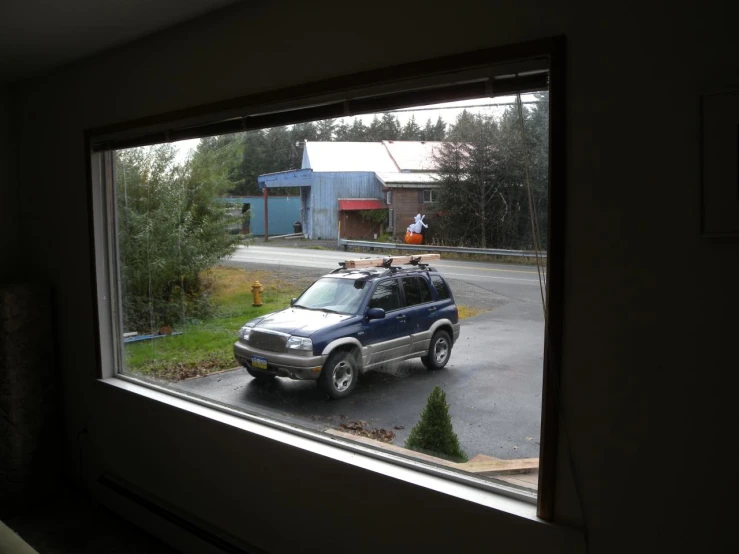 a car is parked at a gas station window