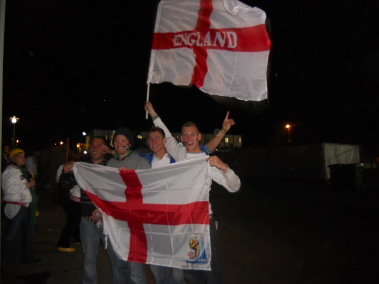 people holding a flag in the air and some other flags