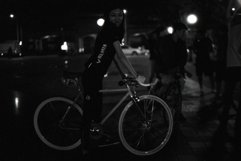 the man is walking with his bike while holding the cellphone