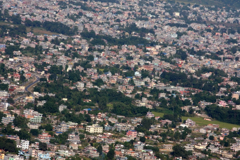 the city is surrounded by trees on this mountain side