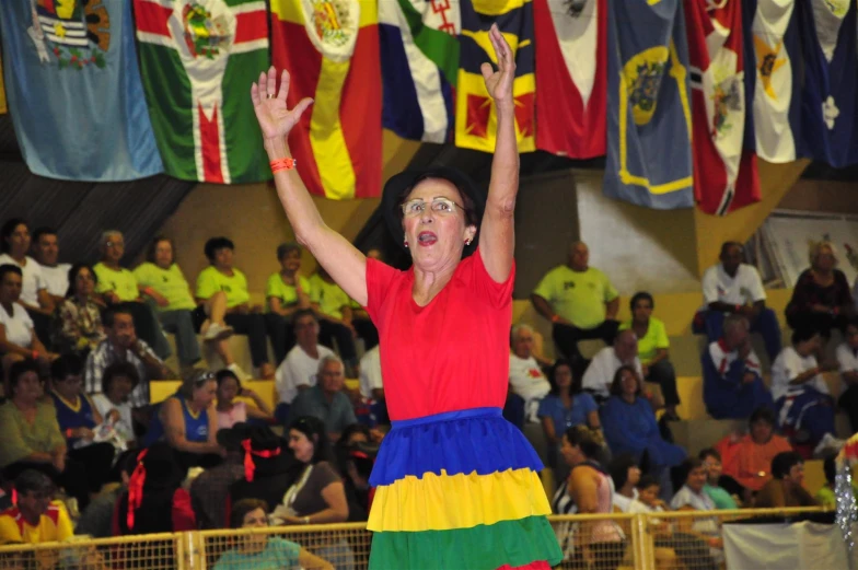 a person wearing colorful clothing celeting at the competition