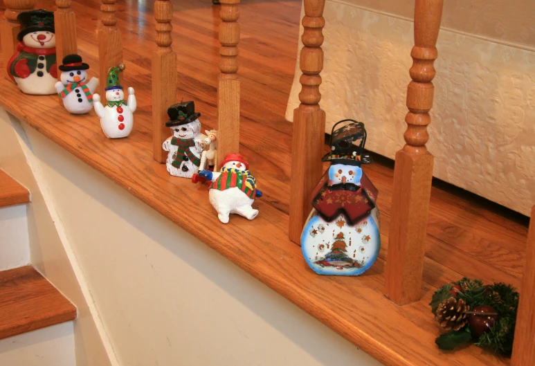 this is a long wooden shelf with snowmen