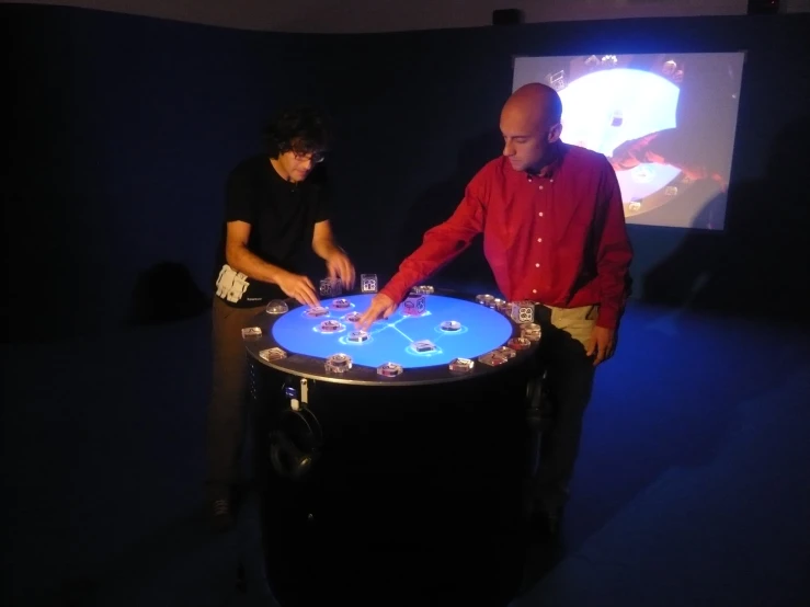 two men are playing games on a circular table