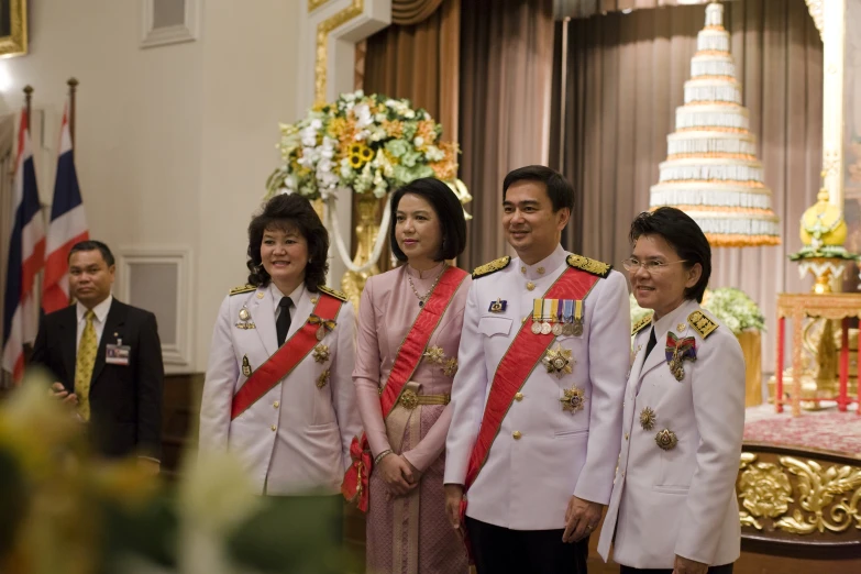 a group of people standing in front of a table