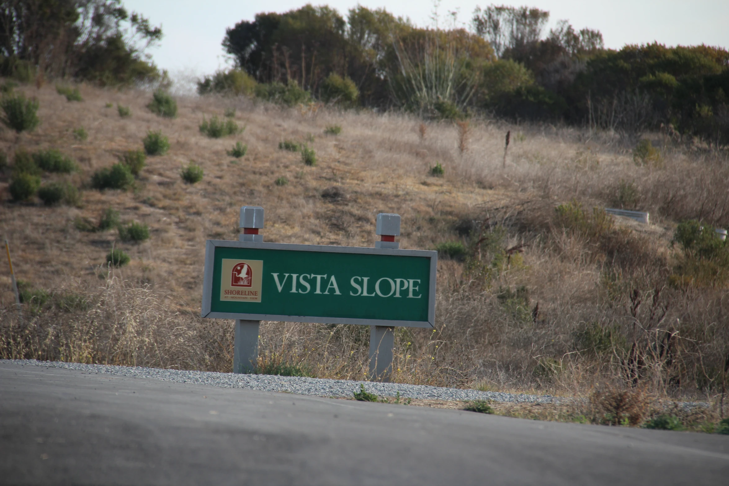 a sign for vista slope sitting on the side of a road