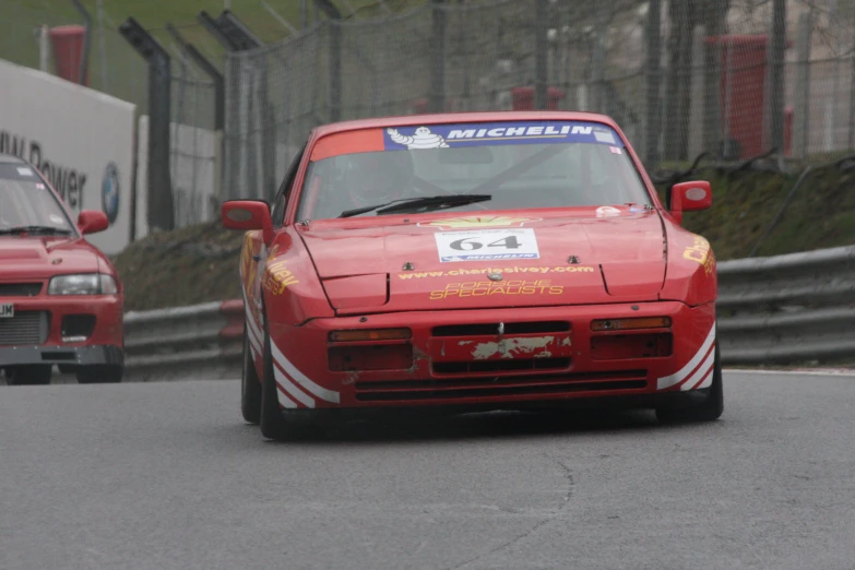 two racing cars on a race track in a race