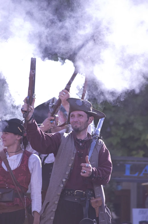 a man with two large guns and two small women holding swords