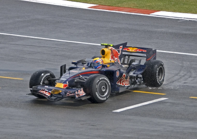 red bull driver in front of the race track