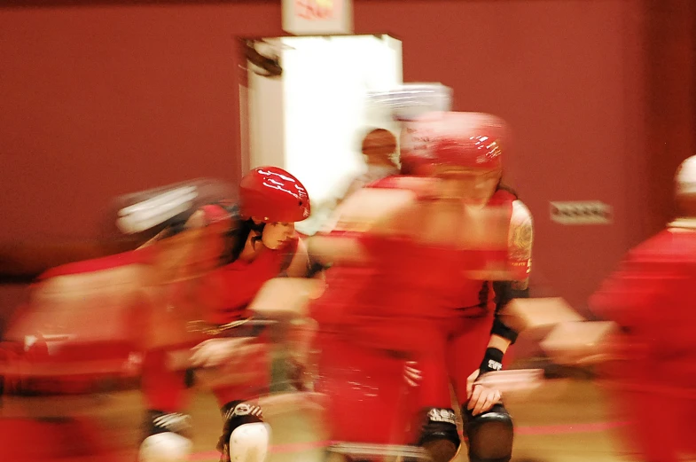 a woman in red and a group of people in red shirts are playing baseball