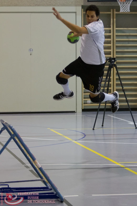 a basketball player jumping to hit a basketball