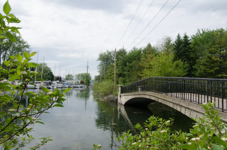 a bridge is going over water with boats in the water