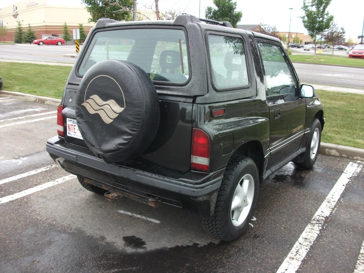 the side of a jeep with a tire cover open