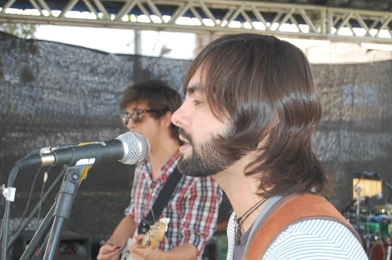 two men at an outdoor band on stage