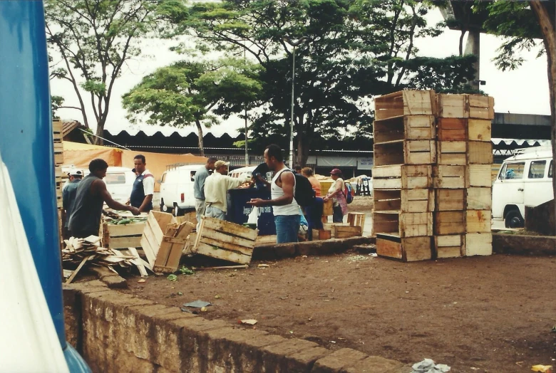 a group of people and some crates of wood