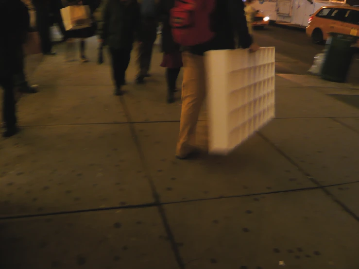 people walking down the street holding shopping bags