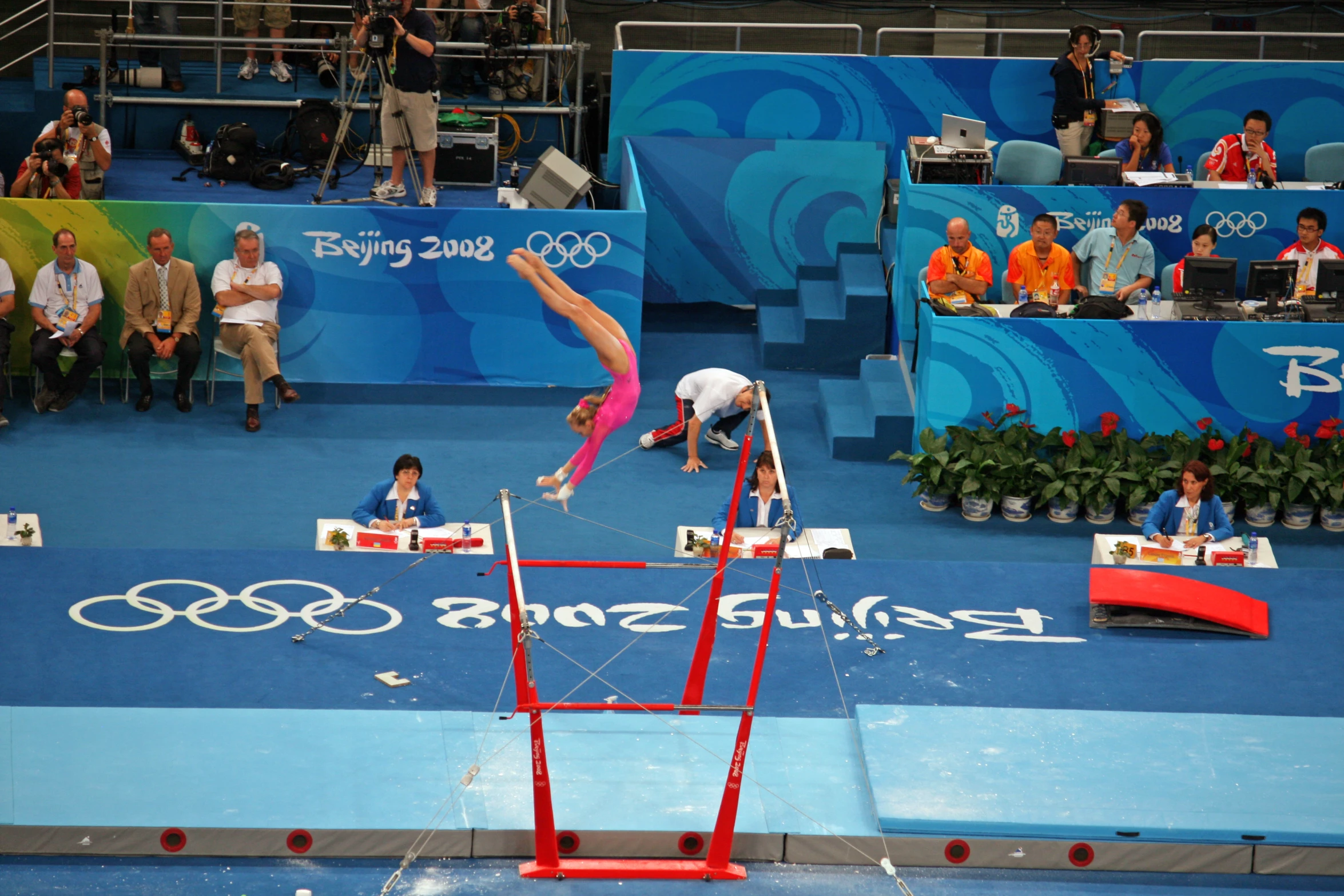 person jumping off a high jump in a gymnastics event