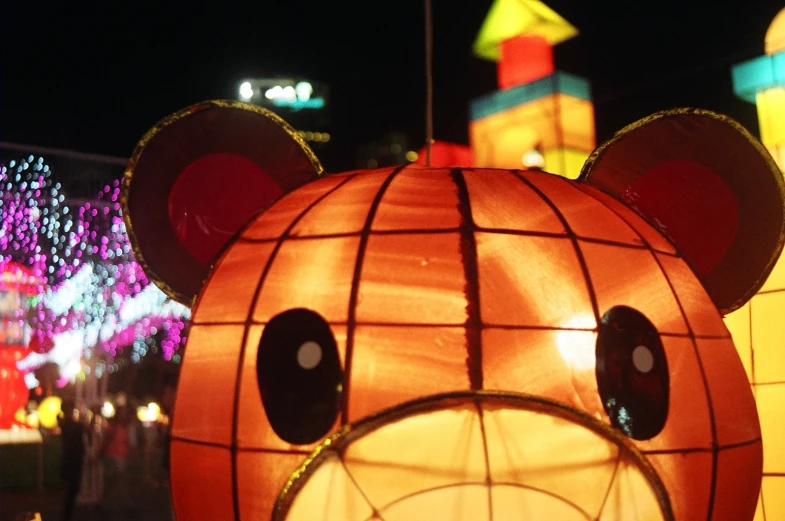 a teddy bear lantern is shown with the faces of the characters