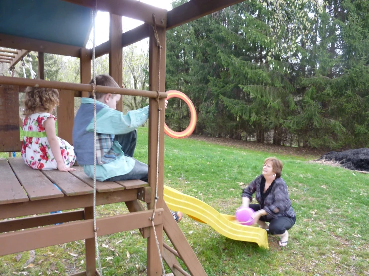 a woman with two children in a park