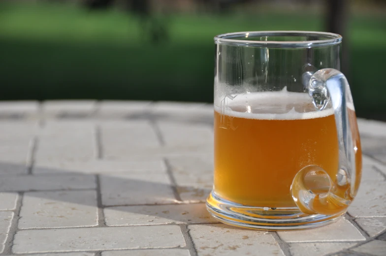 a close up of a mug filled with beer