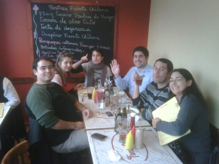 a group of friends sitting down for a meal