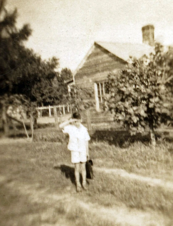 a person walks down a path towards a house