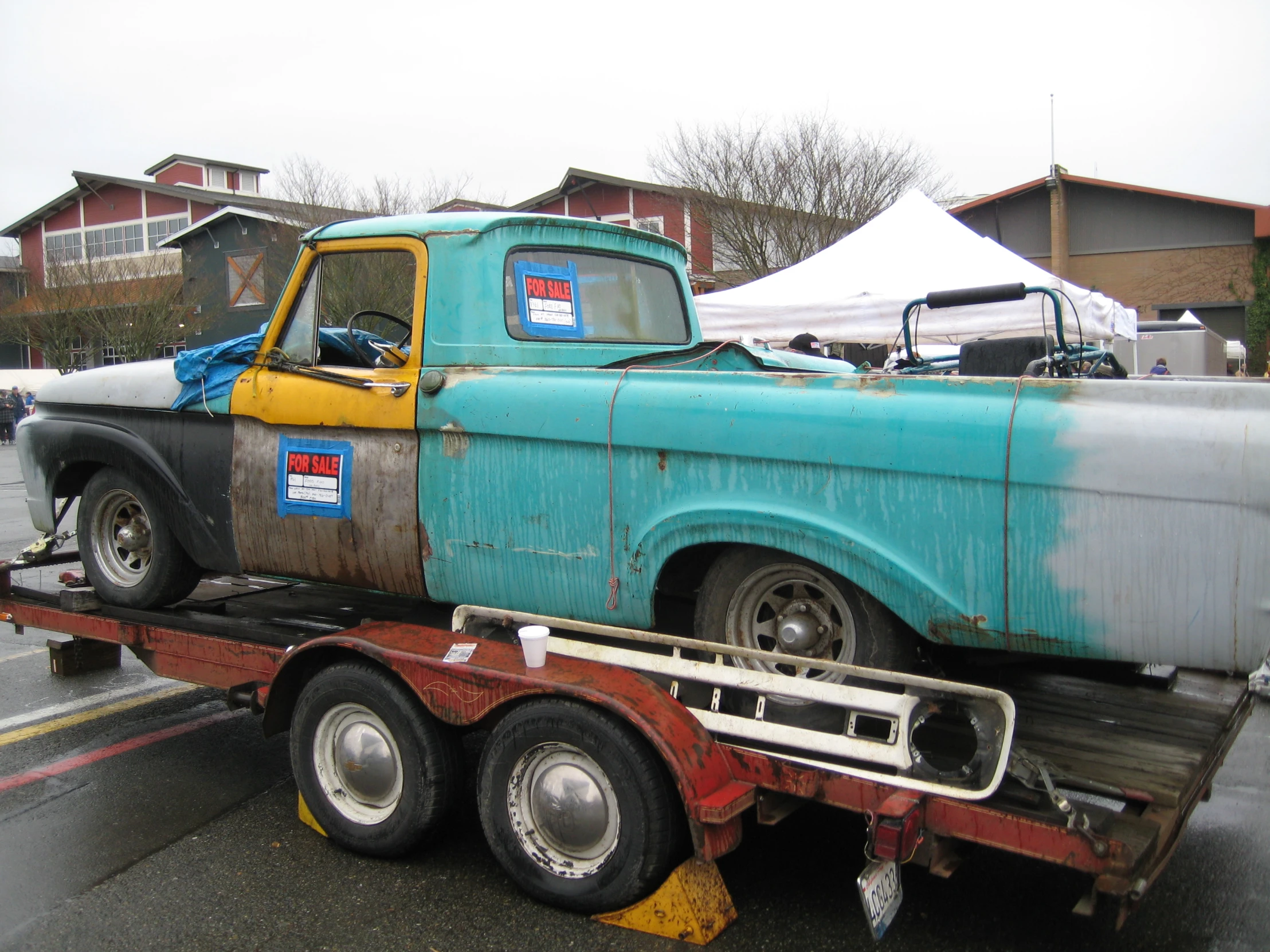 a blue pick up truck parked in a parking lot