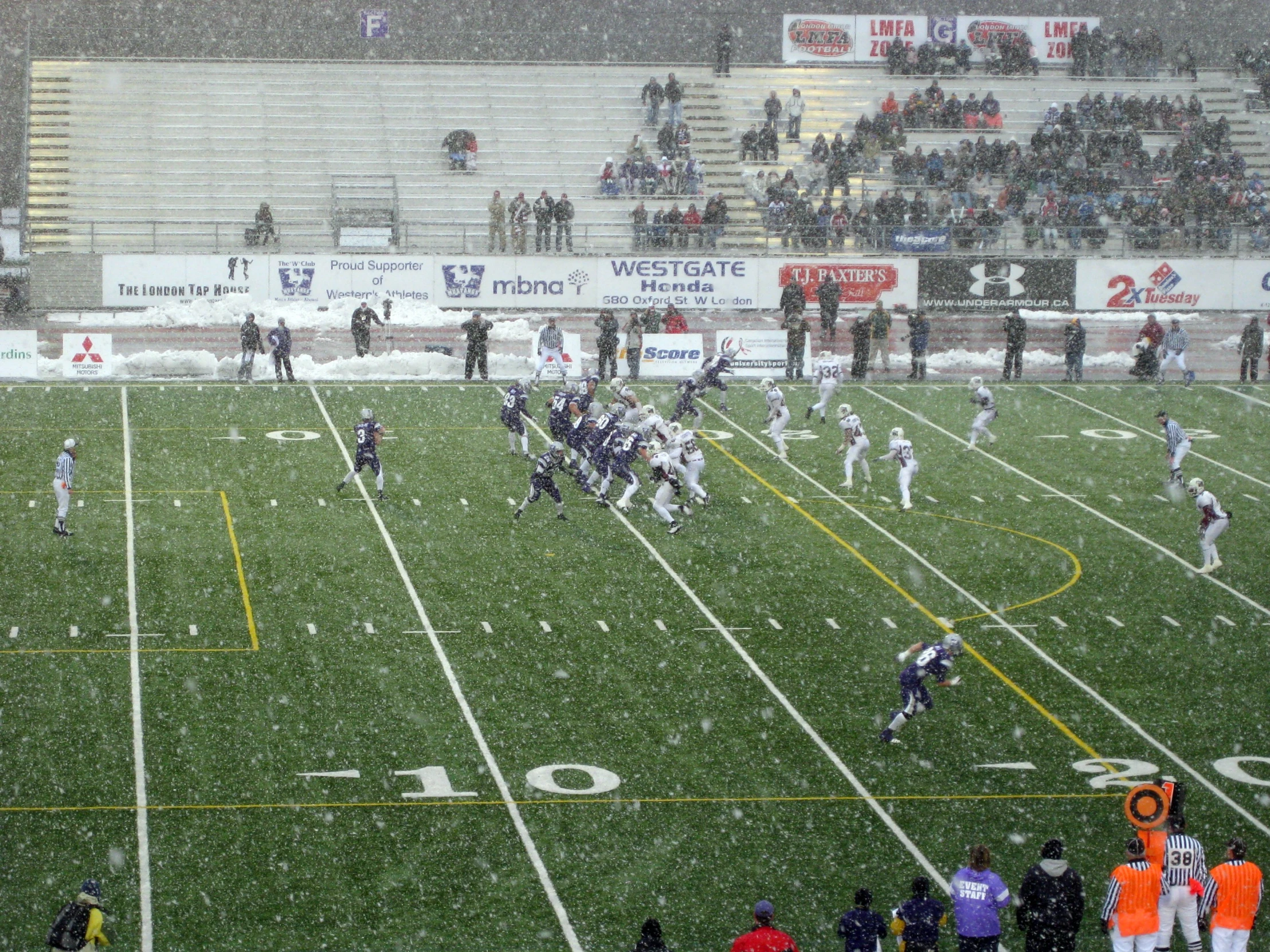 a football game on a field with people watching