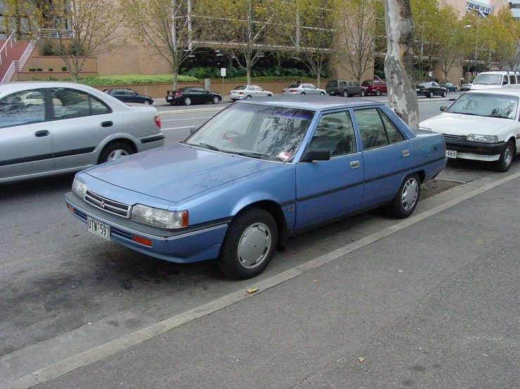 the cars are lined up in a row on the sidewalk