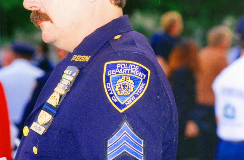 a police officer wearing his uniform with a beard and moustache