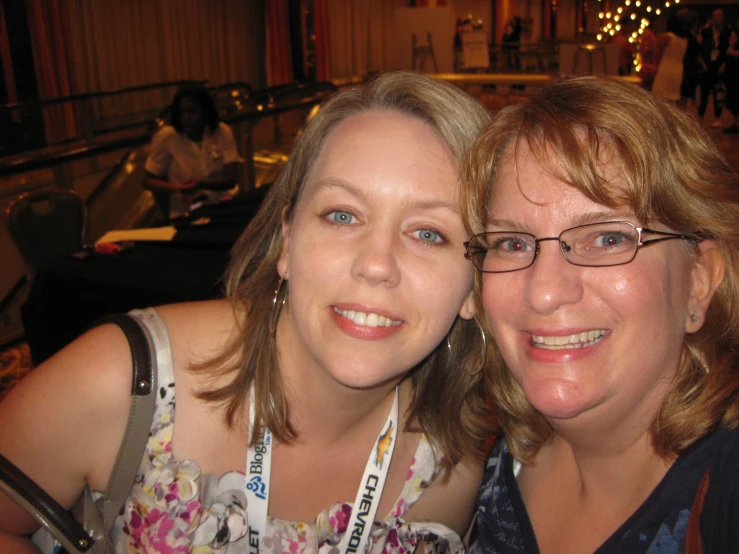 two woman posing for a picture while smiling