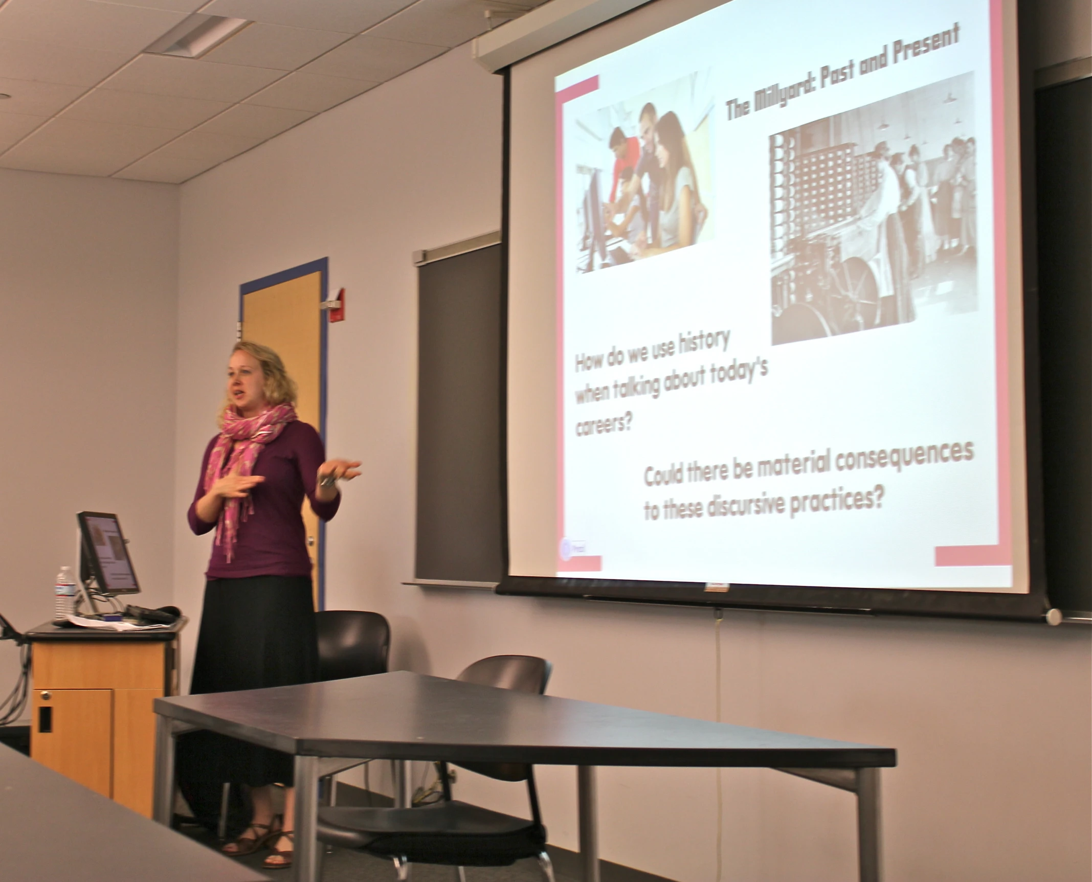 a woman is giving a lecture on business