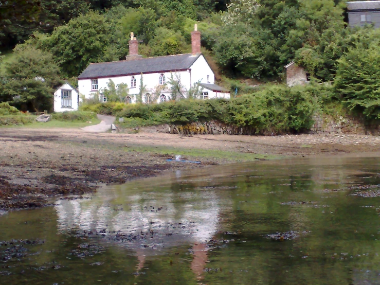 house next to a river in the country side