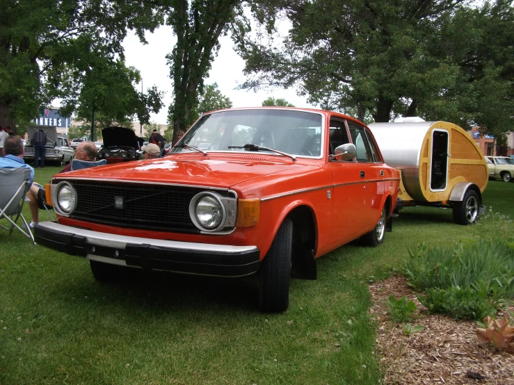 old trucks with campers nearby on the grass