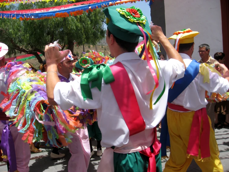 a group of men in mexican outfits dancing together