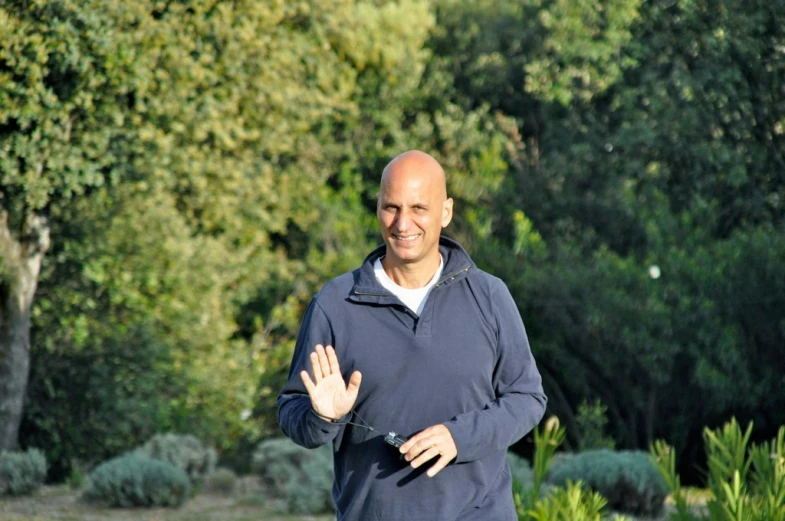 a man that is standing in front of trees