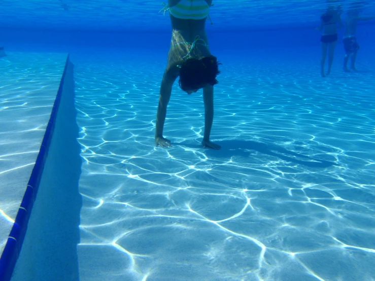 people in the pool are playing and swimming