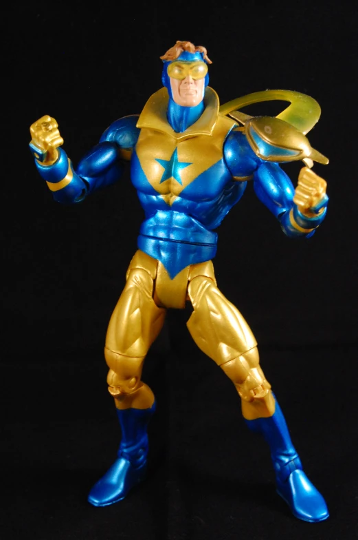 a golden and blue superhero action figure posing for a po