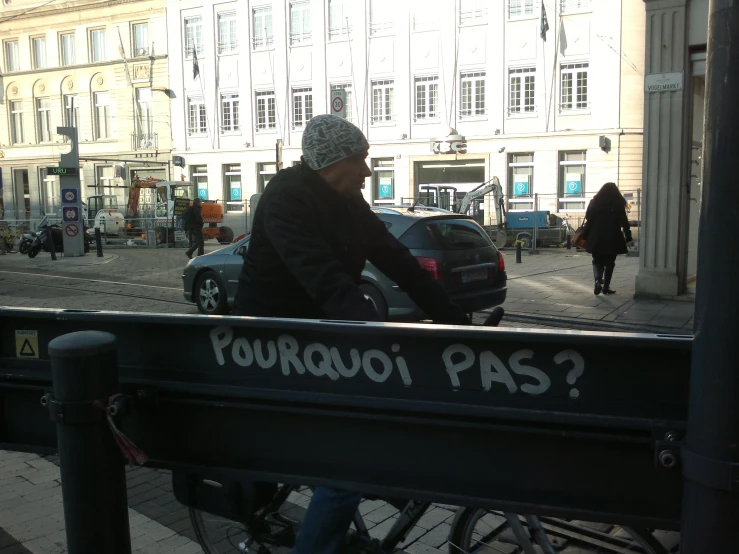 a man riding a bicycle down a street