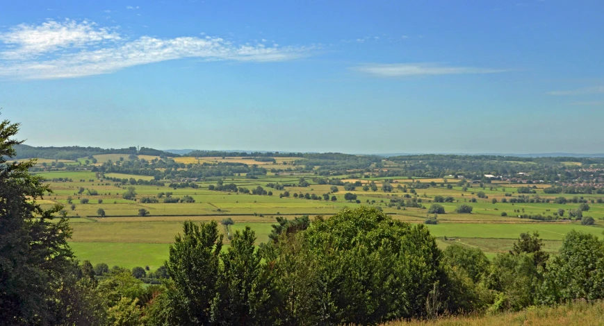 a view of a grassy countryside and rolling hills