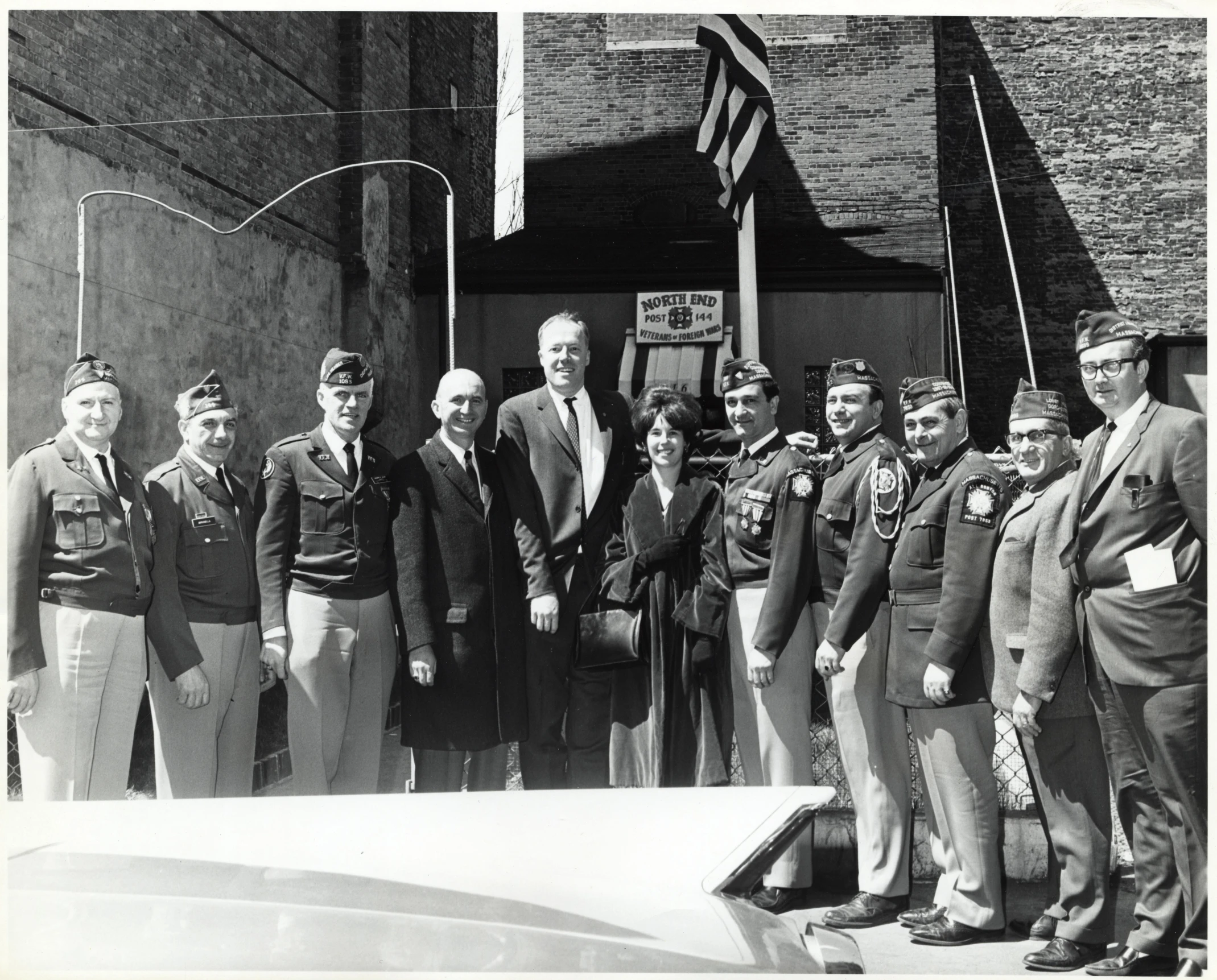 a group of men standing in front of a building