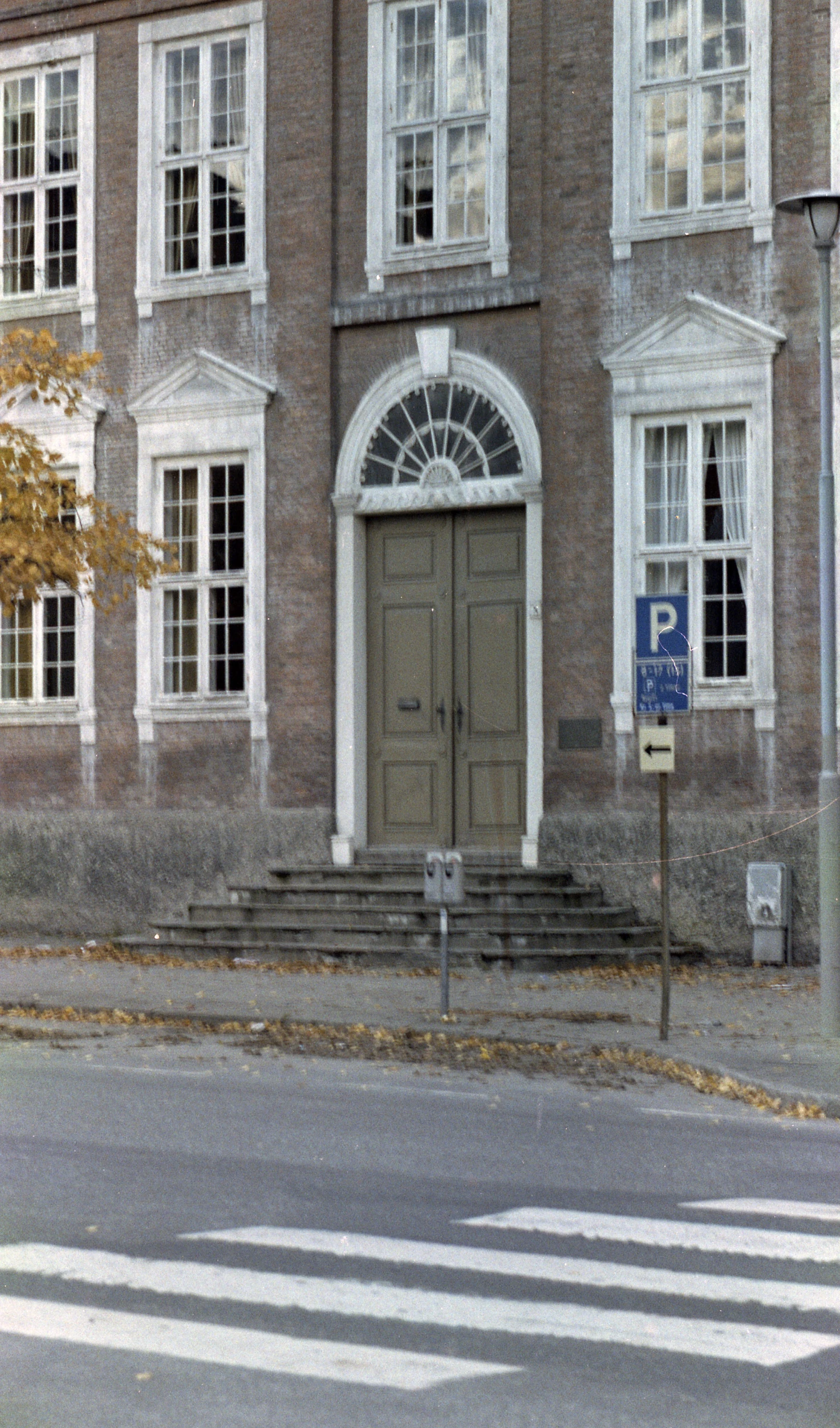 an old brick building has a brown door